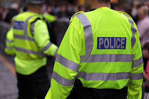 Two police officers from behind