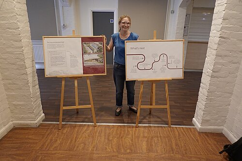 Cllr Kathleen Becker stands with the info board on the Lido