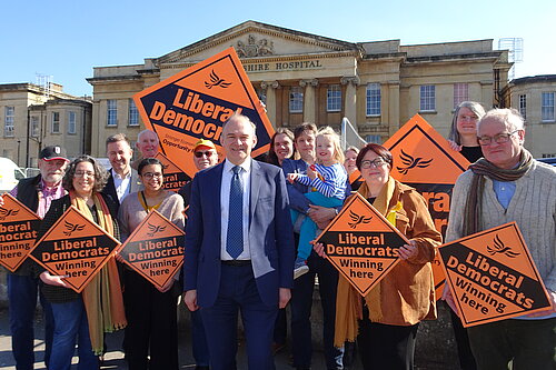 The Reading Liberal Democrats hold placards in front of the Royal Berkshire Hospital with party leader Sir Ed Davey MP